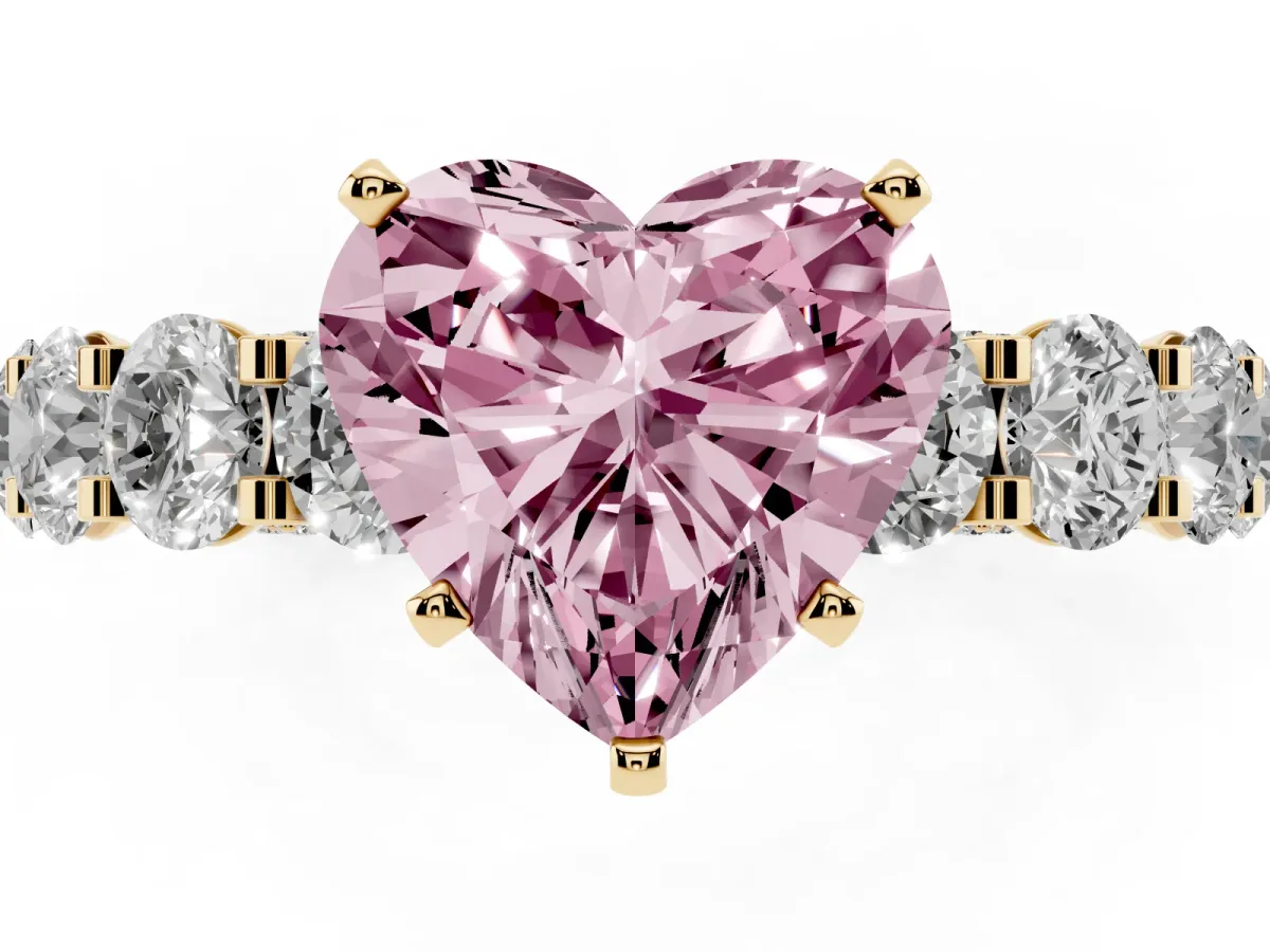 Fancy Pink Heart Cut Diamond Side Stone Engagement Ring with Four-Prong Setting Yellow gold