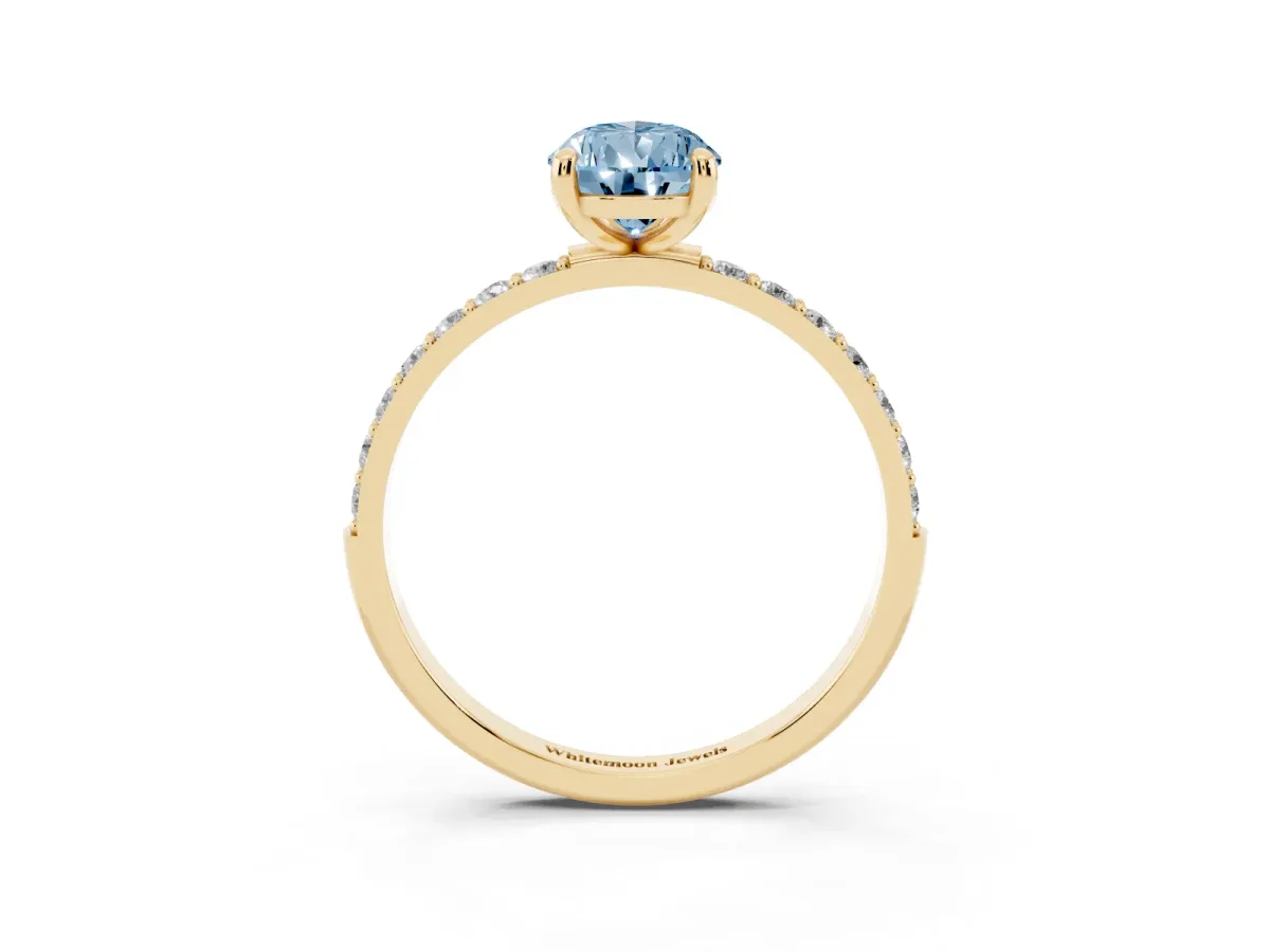 Fancy Blue Pear Cut Diamond Solitaire Ring with Round Pavé Band and Prong Setting Yellow gold