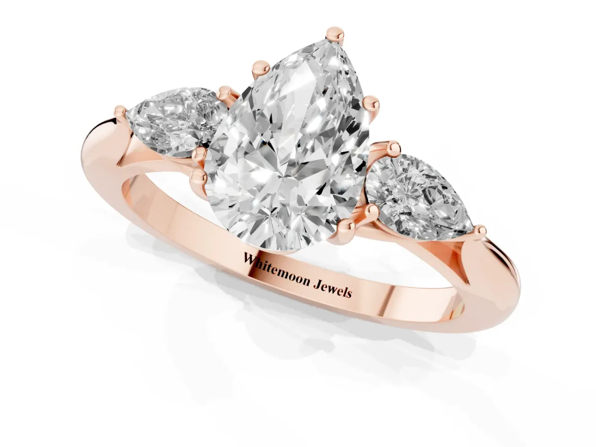 Three-Stone Pear Cut Diamond Ring with Pear Side Stones in Four-Prong Setting Rose gold