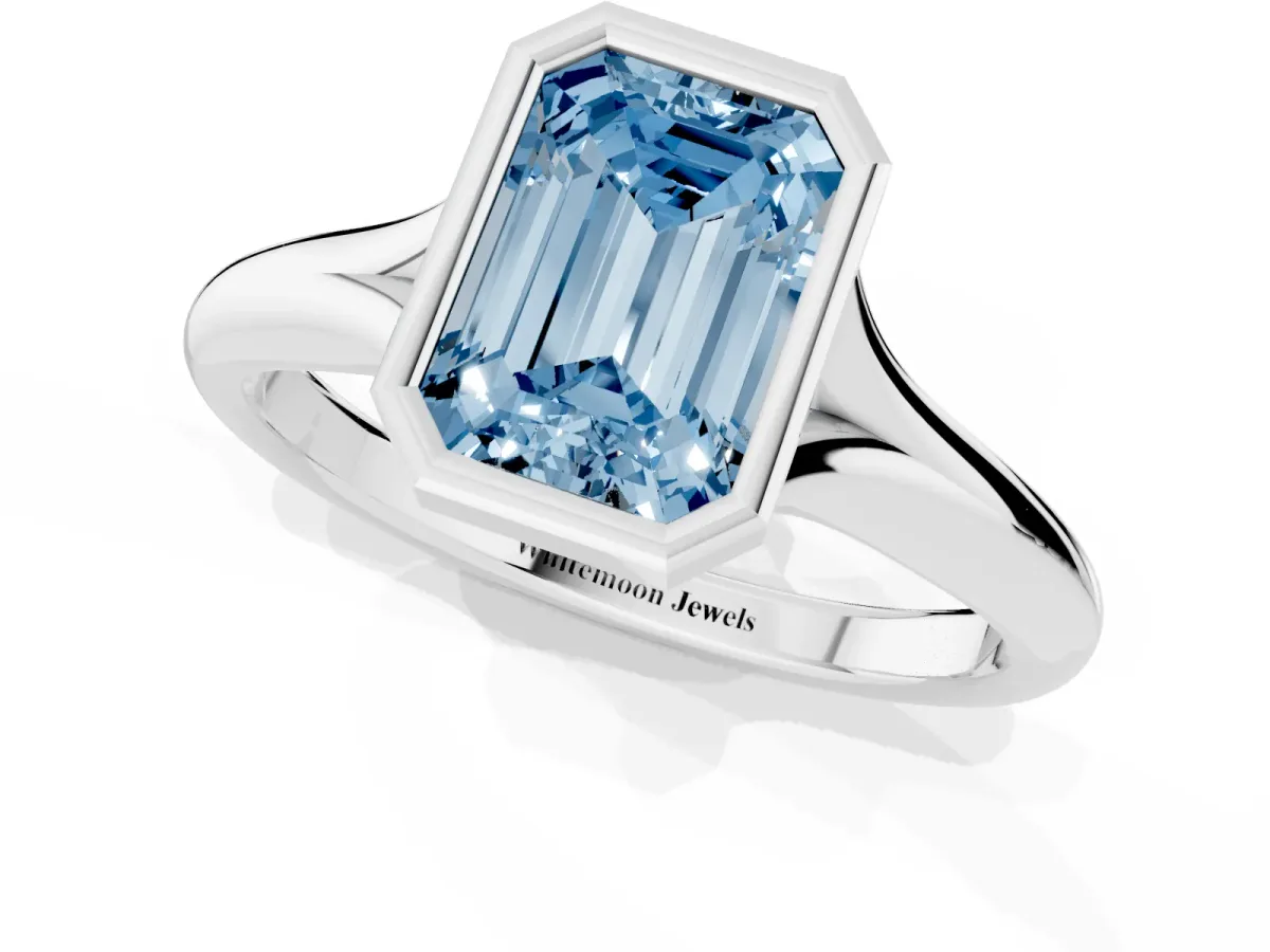 Fancy Blue Bezel Set Emerald Cut Solitaire Diamond Ring with Smooth Band Silver