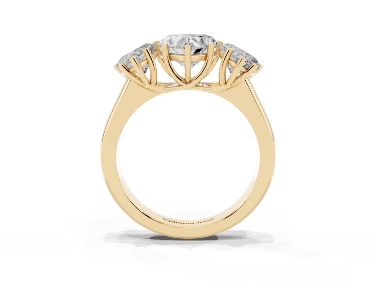 Heart Cut Three-Stone Diamond Ring with Prong Setting on a Classic Band Yellow gold