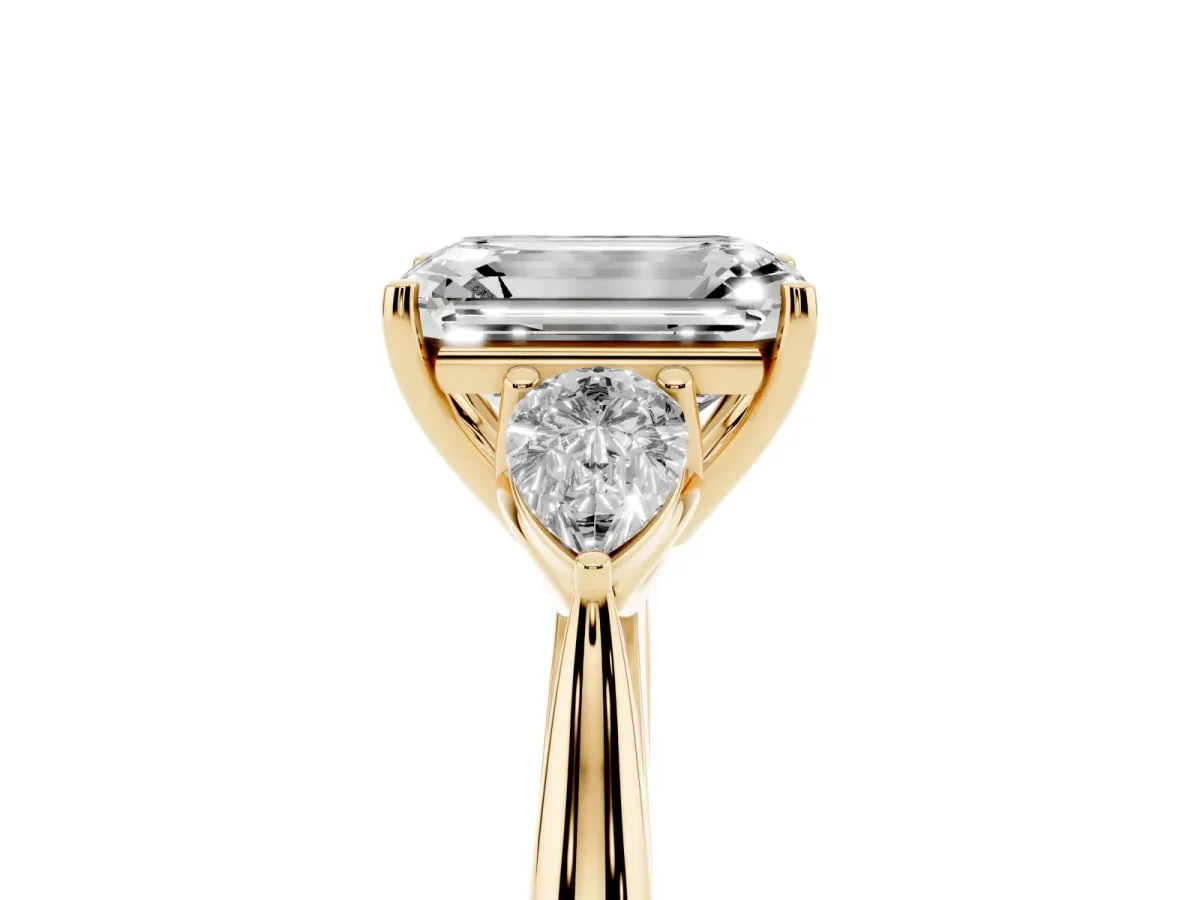 Three-Stone Emerald Cut Brilliant Diamond Solitaire Ring with Tapered Band and Four-Prong Setting Yellow gold
