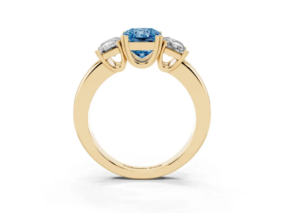 Fancy Blue Three-Stone Radiant Cut Cut Diamond Ring with Channel Set Band and Four-Prong Setting Yellow gold