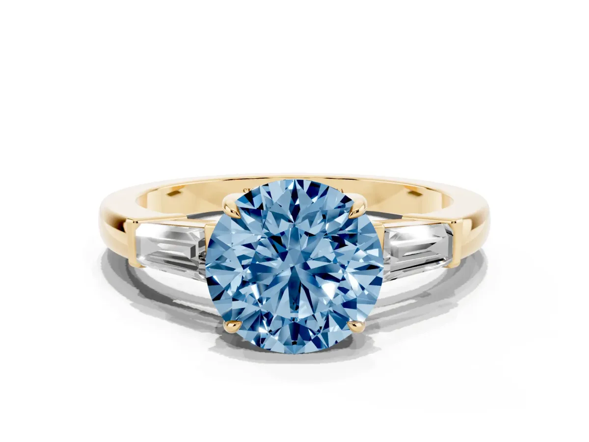Fancy Blue Round Cut Diamond Three-Stone Ring with Tapered Baguette Side Stones and Prong Setting Yellow gold
