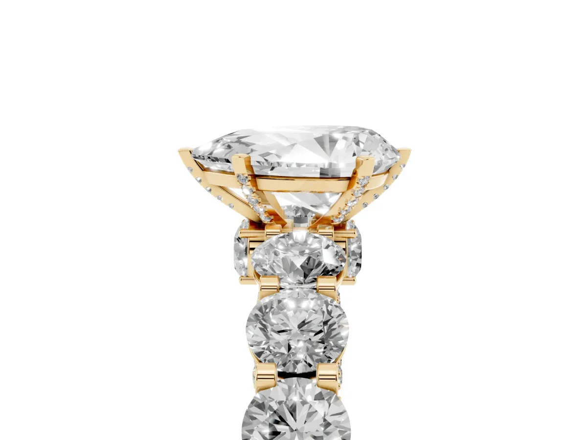 Pear Cut Diamond Side Stone Engagement Ring with Four-Prong Setting Yellow gold