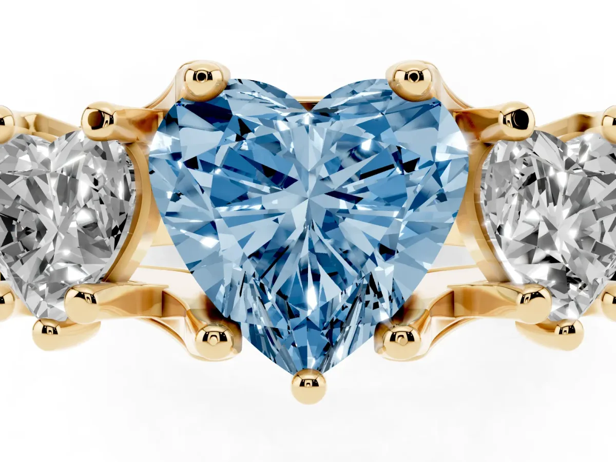 Fancy Blue Heart Cut Diamond Three-Stone Ring with Channel Set Band and Four-Prong Setting Yellow gold
