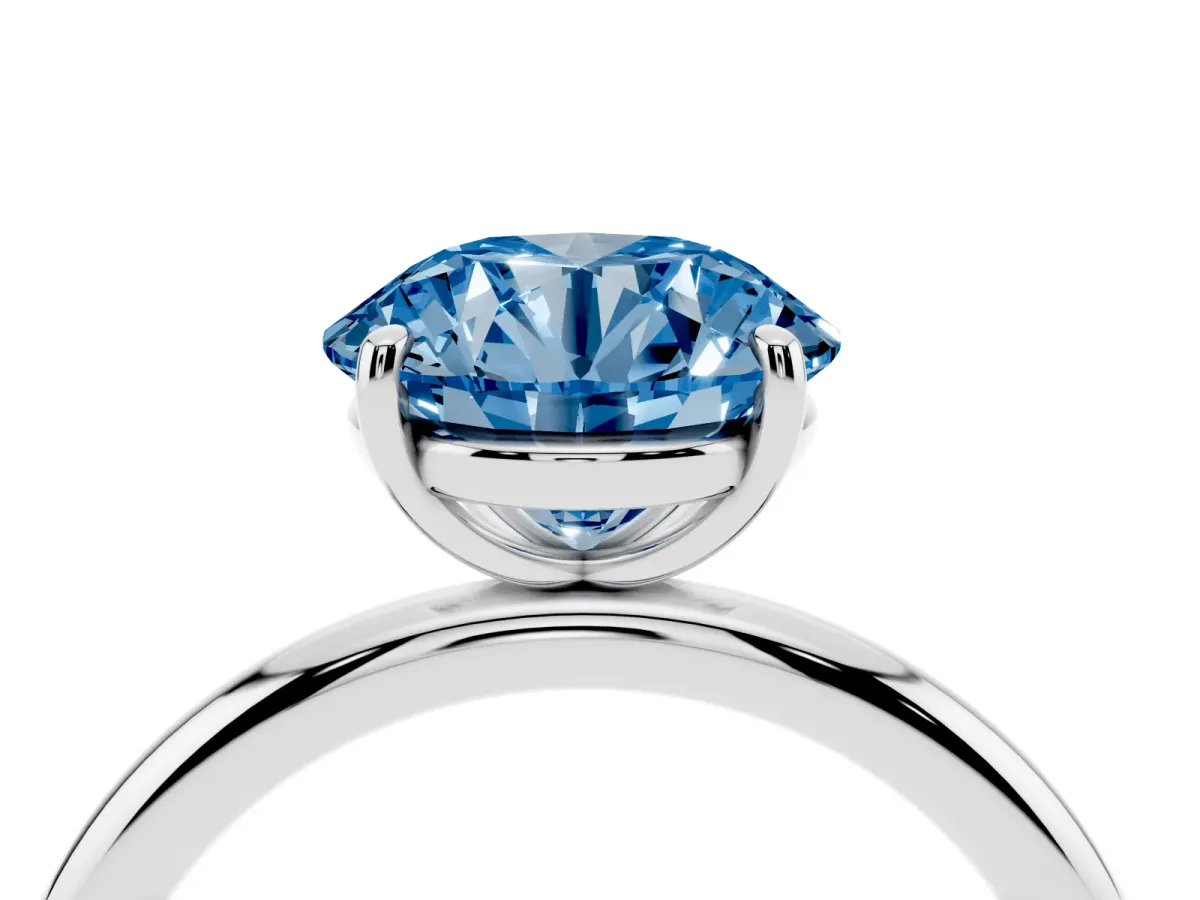 Fancy Blue Round Cut Solitaire Diamond Ring with Four-Prong Setting on a Plain Band Silver