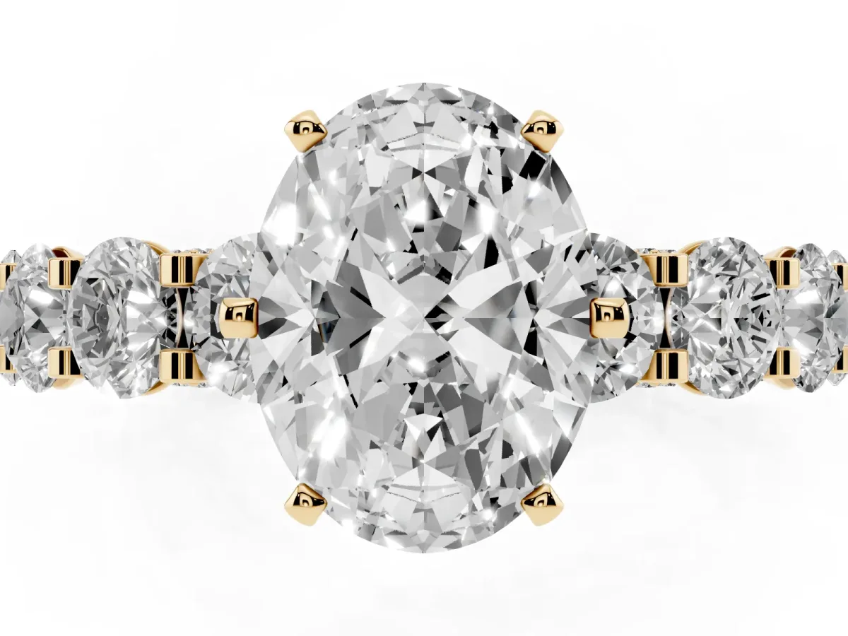 Oval Cut Diamond Side Stone Engagement Ring with Four-Prong Setting Yellow gold