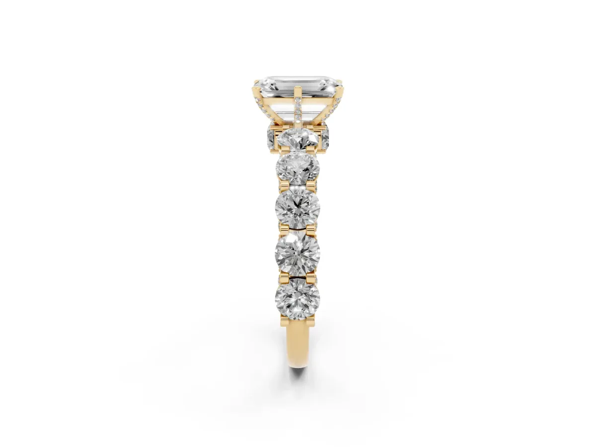 Emerald Cut Diamond Side Stone Engagement Ring with Four-Prong Setting Yellow gold