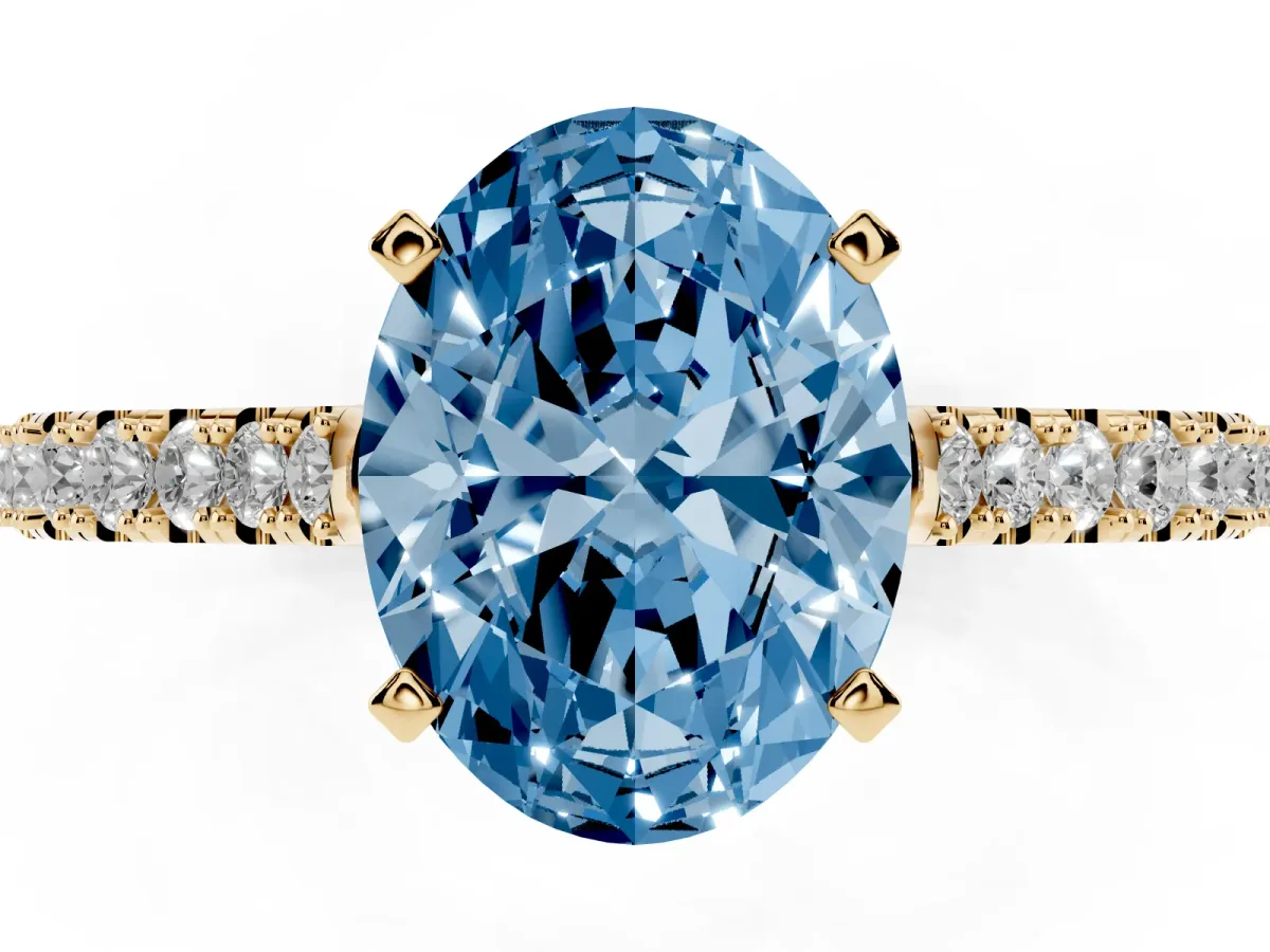 Fancy Blue Oval Cut Cut Solitaire Diamond Engagement Ring with Pave Band and Four-Prong Setting Yellow gold