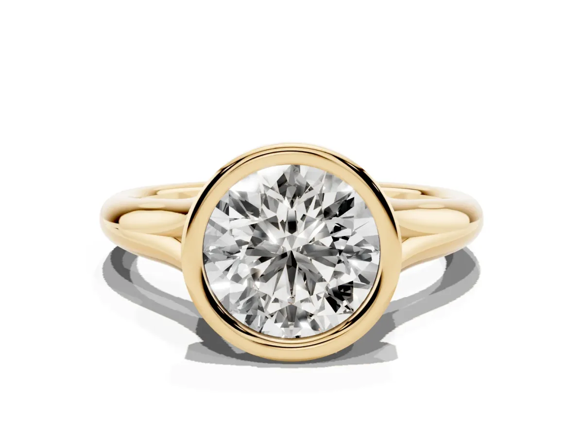 Bezel Set Round Cut Solitaire Diamond Ring with Smooth Band Yellow gold