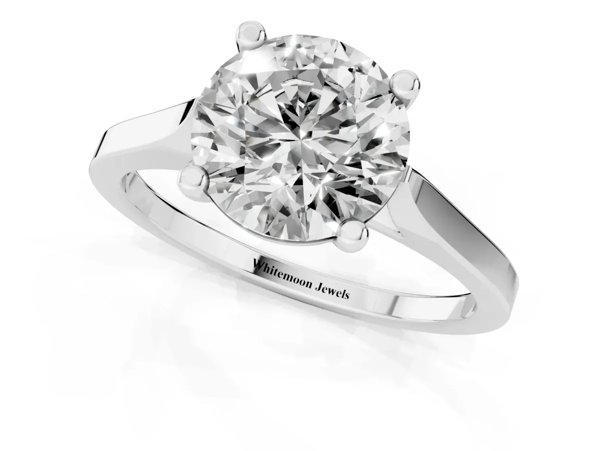 Round Cut Solitaire Diamond Ring with Four-Prong Setting and Tapered Band Platinum