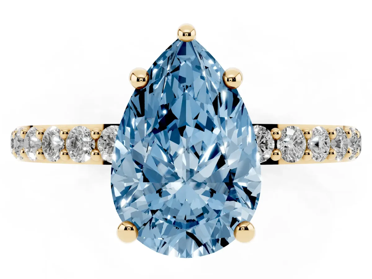 Fancy Blue Pear Cut Diamond Solitaire Ring with Round Pavé Band and Prong Setting Yellow gold