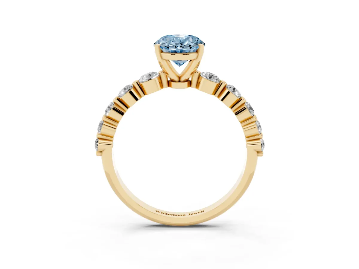 Fancy Blue Oval Cut Solitaire Diamond Ring with Pave Band and Four-Prong Setting Yellow gold