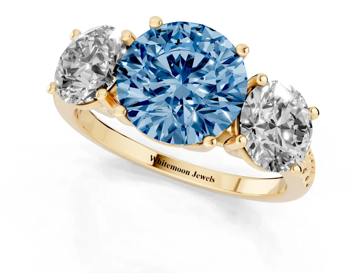 Fancy Blue Three-Stone Round Cut Diamond Ring with Round Pavé Band and Prong Setting Yellow gold