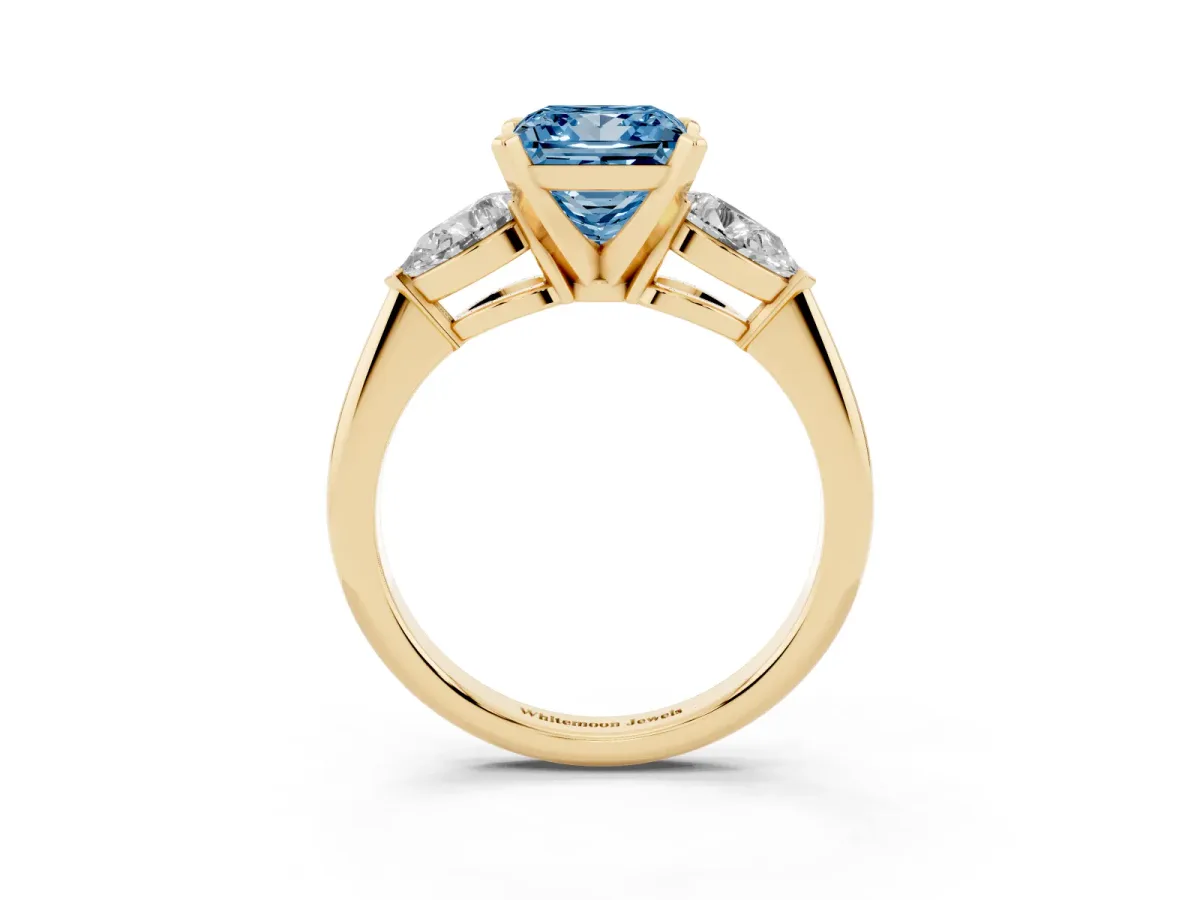 Fancy Blue Three-Stone Princess Cut Diamond Ring with Pear Side Stones and Four-Prong Setting Yellow gold