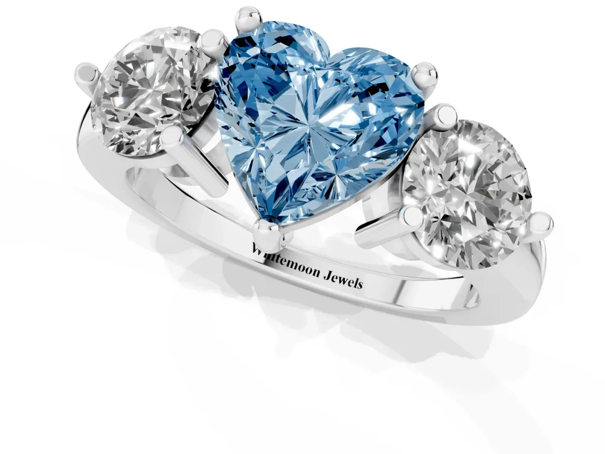 Fancy Blue Three-Stone Heart Cut Brilliant Cut Solitaire Ring with Prong Setting on a Classic Band Silver