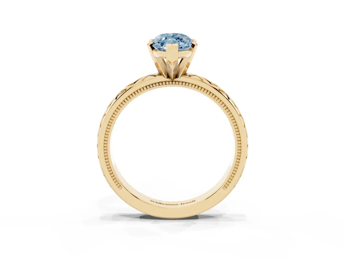 Fancy Blue Marquise Cut Solitaire Diamond Ring with Milgrain and Black Enamel X Pattern Band Yellow gold