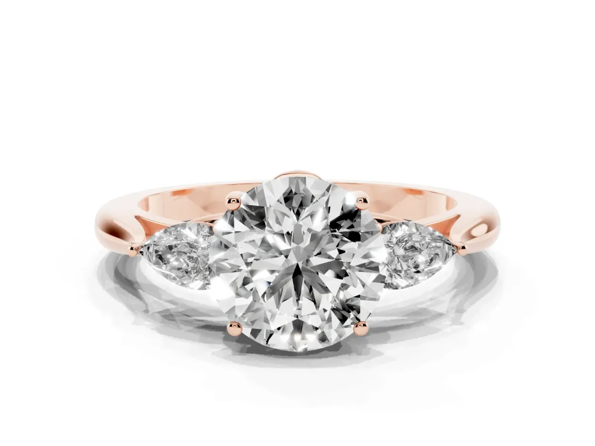 Round Cut Diamond Three-Stone Ring with Pear Side Stones and Prong Setting Rose gold