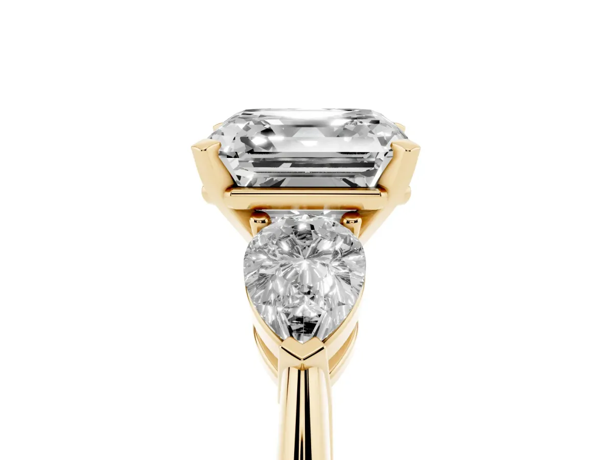 Three-Stone Asscher Cut Diamond Ring with Pear Side Stones and Four-Prong Setting Yellow gold