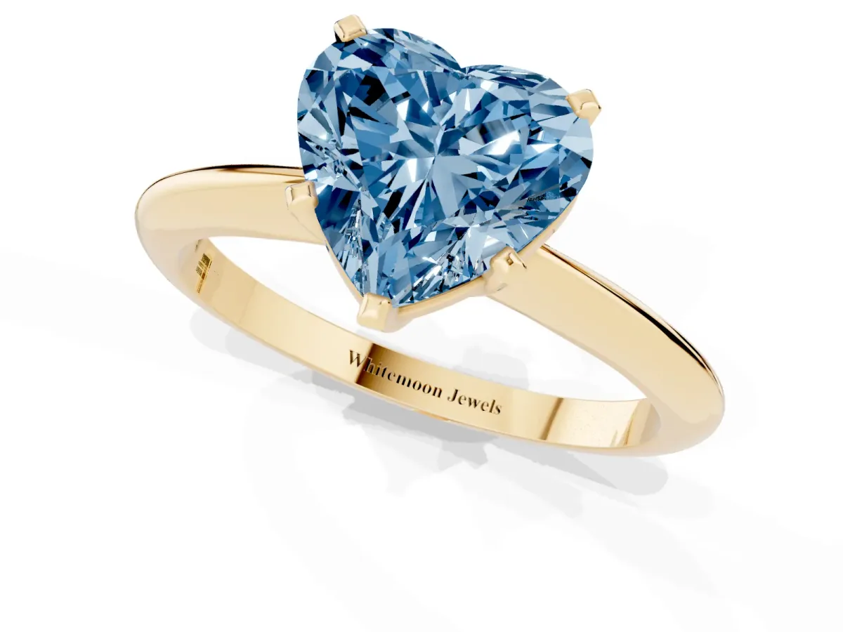 Fancy Blue Heart Cut Cut Solitaire Ring with Four-Prong Setting on a Classic Band Yellow gold
