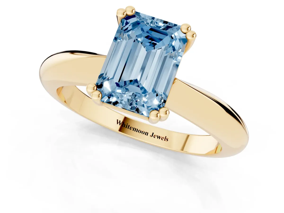 Fancy Blue Emerald Cut Cut Solitaire Engagement Ring with Tapered Band and Four-Prong Setting Yellow gold