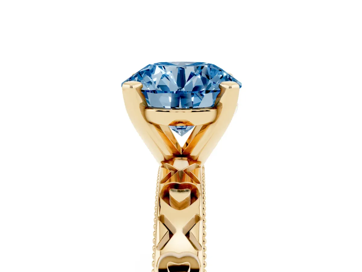 Fancy Blue Round Cut Solitaire Diamond Engagement Ring with XO Engraved Band and Four-Prong Setting Yellow gold