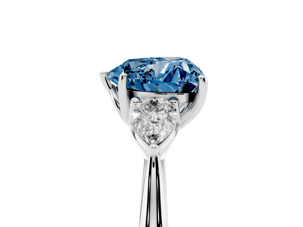 Fancy Blue Three-Stone Heart Cut Brilliant Diamond Solitaire Ring with Tapered Band and Four-Prong Setting White gold