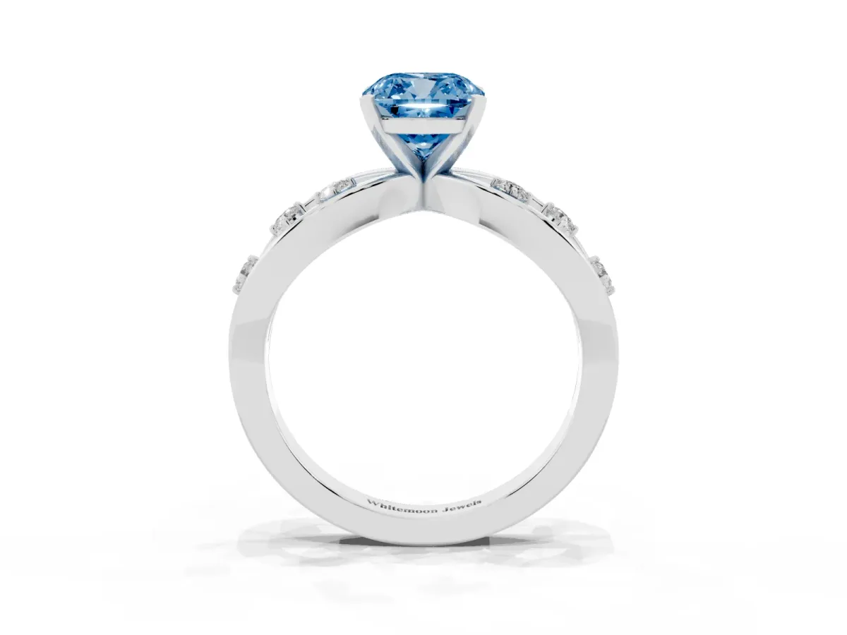 Fancy Blue Cushion Cut Cut Solitaire Diamond with Side Stones on Criss-Cross Band and Four-Prong Setting Silver
