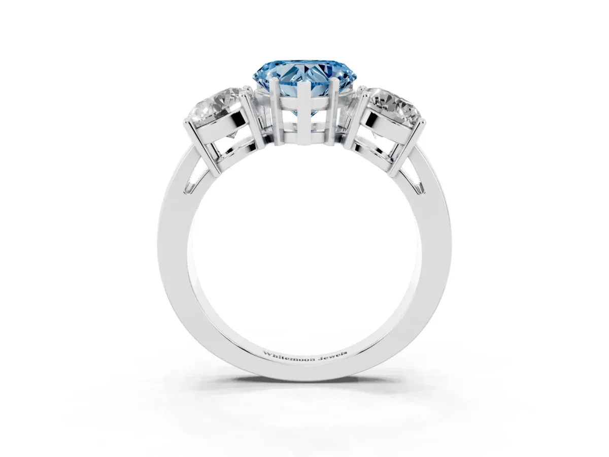 Fancy Blue Three-Stone Heart Cut Diamond Ring with Round Side Stones, Classic Band, and Four-Prong Setting Platinum