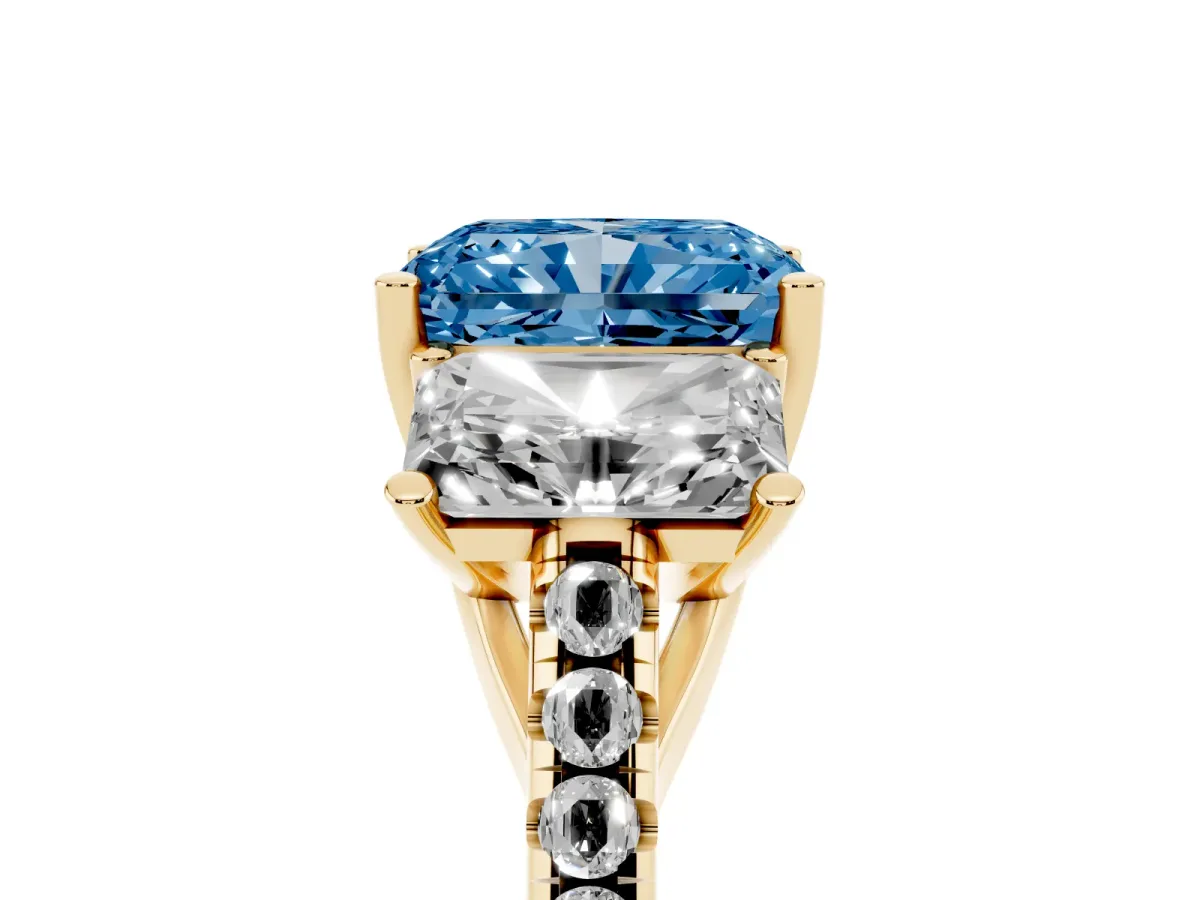 Fancy Blue Three-Stone Radiant Cut Diamond Ring with Round Pavé Band and Prong Setting Yellow gold