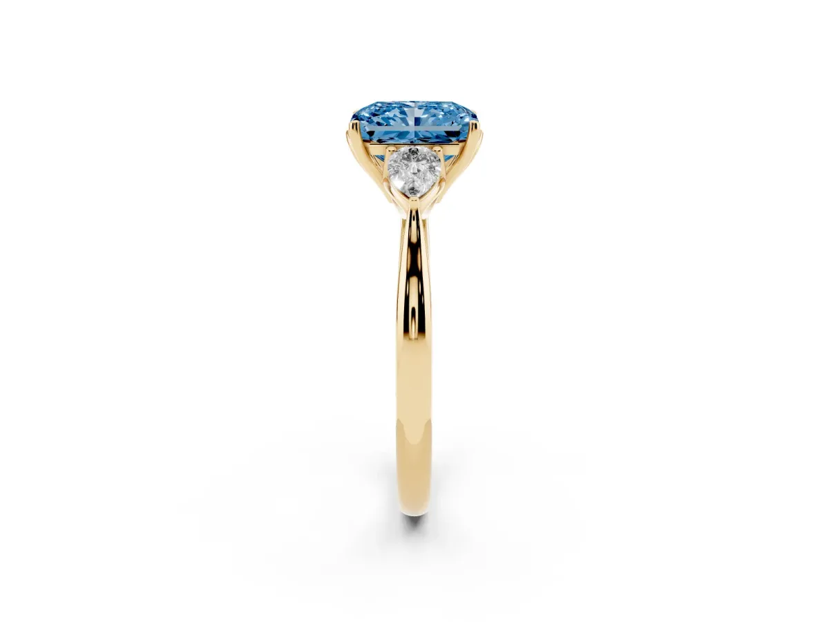 Fancy Blue Three-Stone Radiant Cut Diamond Ring with Pear Side Stones in Four-Prong Setting Yellow gold