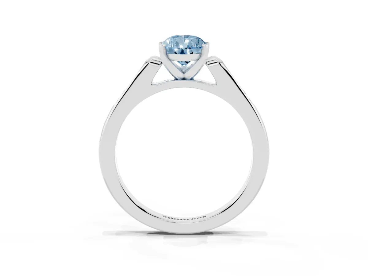 Fancy Blue Pear Cut Diamond Solitaire Ring with Channel Set Round Band and Prong Setting Silver
