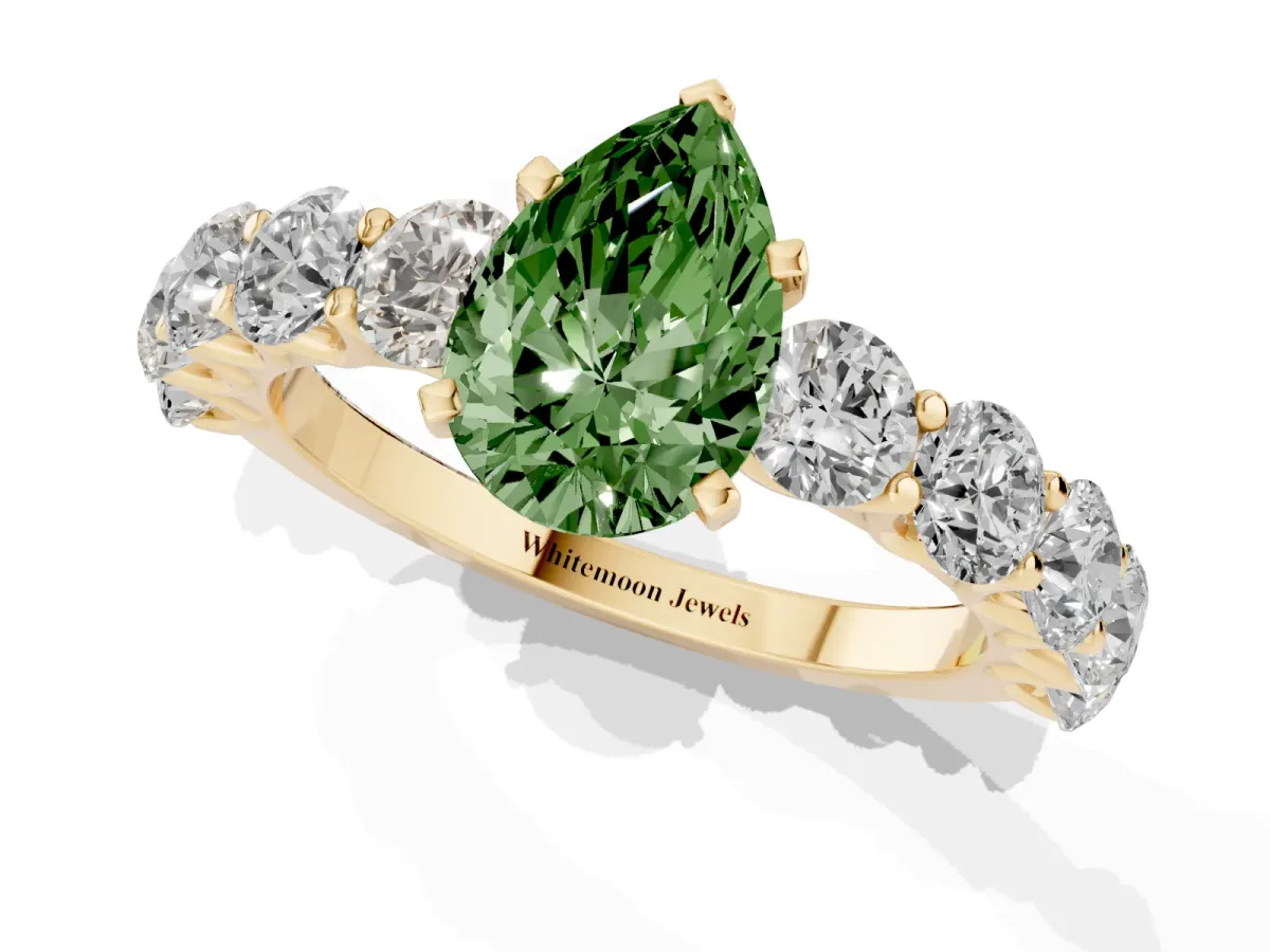 Fancy Green Pear Cut Diamond Prong Setting with Side Stones on a Pave Band Yellow gold