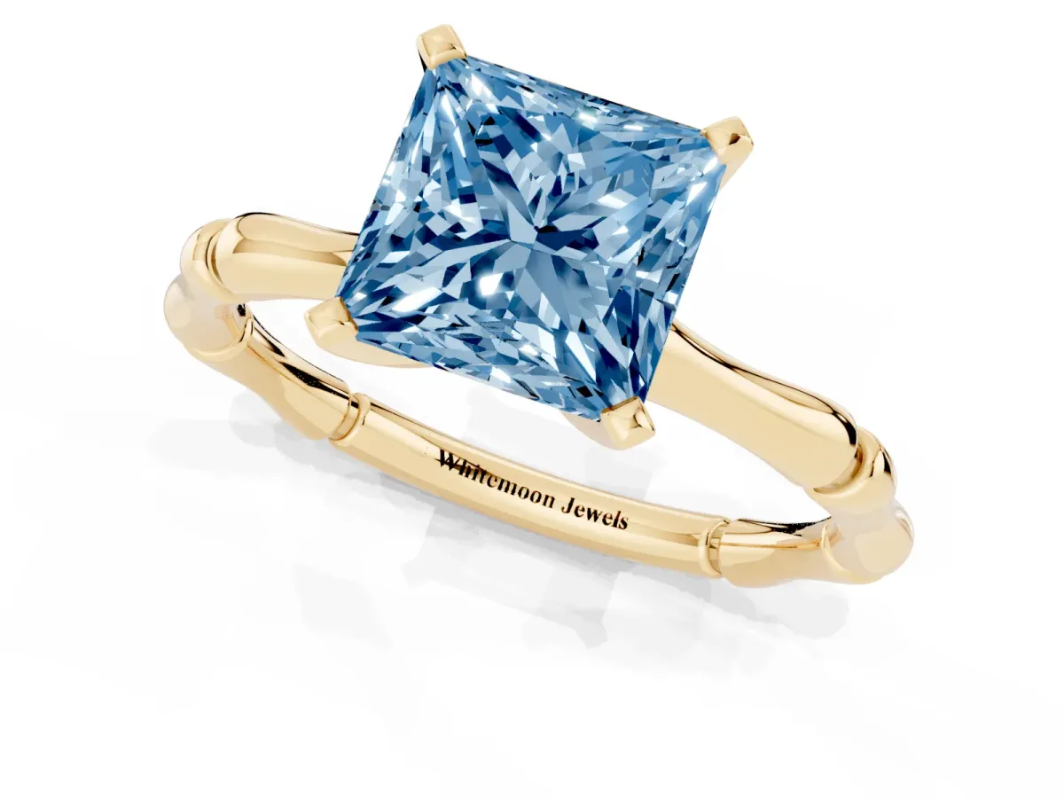 Fancy Blue Princess Cut Solitaire Diamond Ring with Bamboo Band and Four-Prong Setting Yellow gold