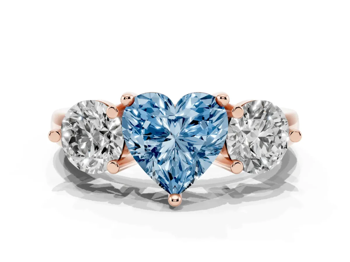 Fancy Blue Three-Stone Heart Cut Brilliant Cut Solitaire Ring with Prong Setting on a Classic Band Rose gold