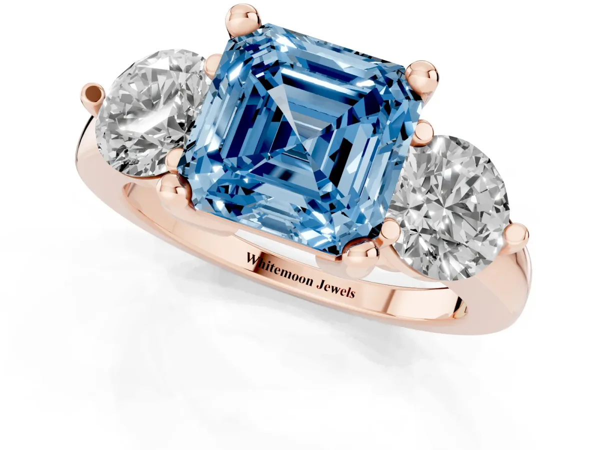 Fancy Blue Three-Stone Asscher Cut Brilliant Cut Solitaire Ring with Prong Setting on a Classic Band Rose gold