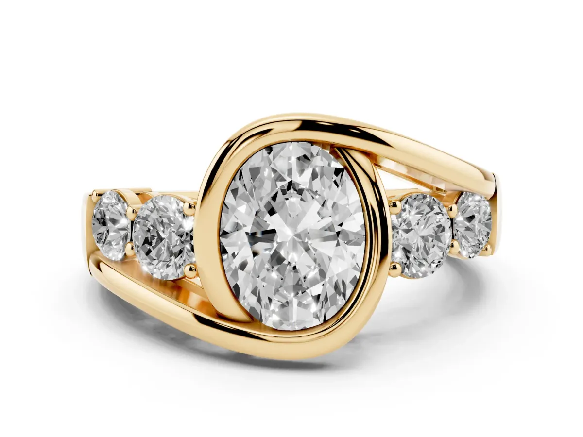 Bezel Set Oval Cut Diamond Bypass Ring with Round Accents Yellow gold