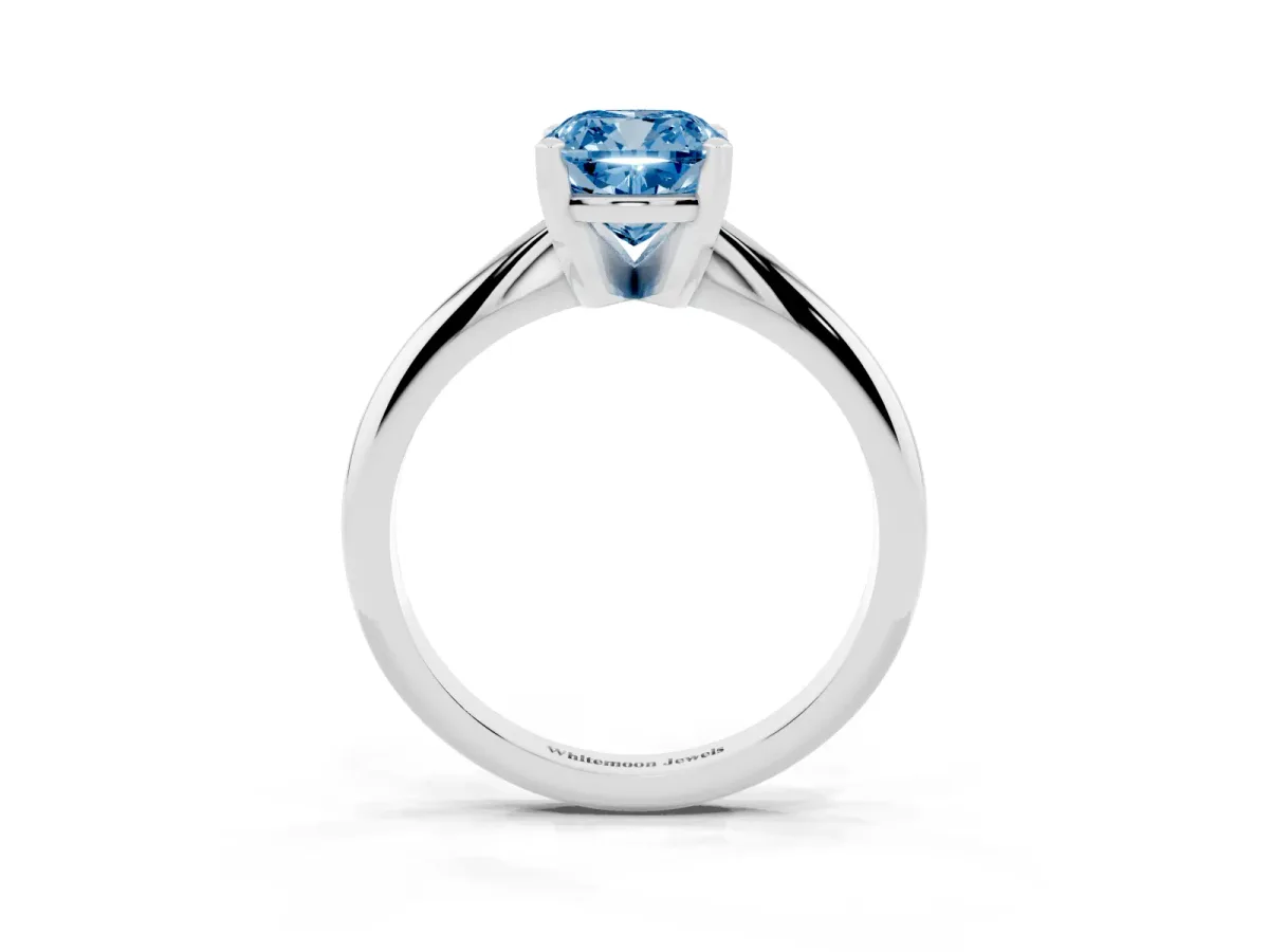 Fancy Blue Cushion Cut Cut Solitaire Ring with Four-Prong Setting on a Classic Band Silver