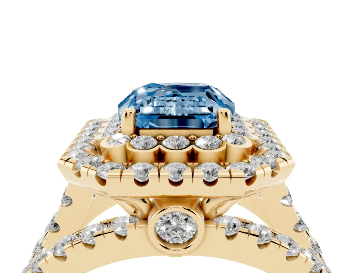 Fancy Blue Emerald Cut Diamond Double Halo Ring with Round Pavé Split Shank and Prong Setting Yellow gold