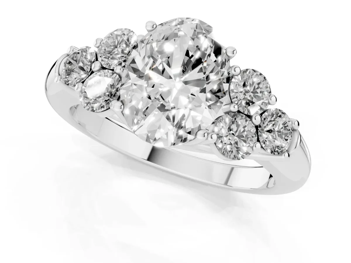 Oval Cut Cut Diamond Cluster Ring with Round Accent Stones and Prong Setting on a Classic Band White gold
