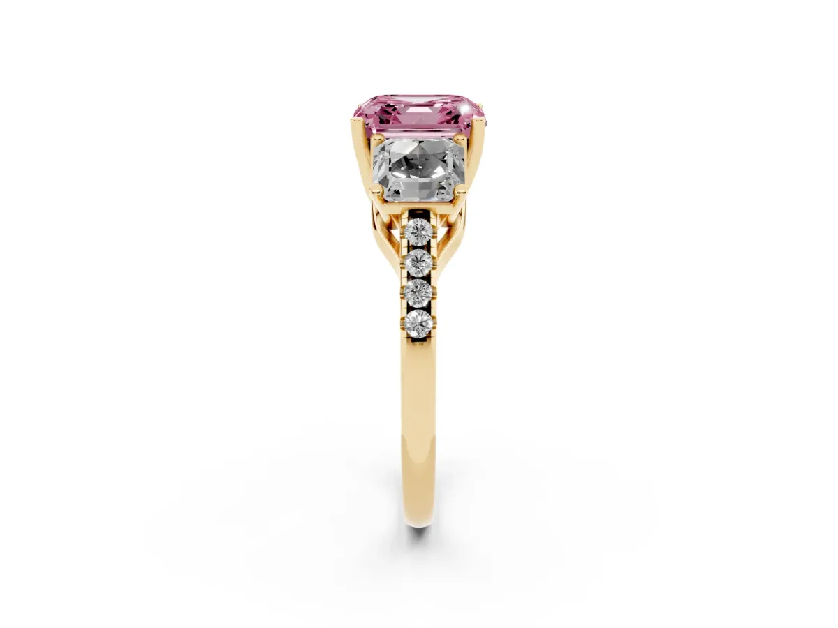Fancy Pink Three-Stone Asscher Cut Diamond Ring with Round Pavé Band and Prong Setting Yellow gold
