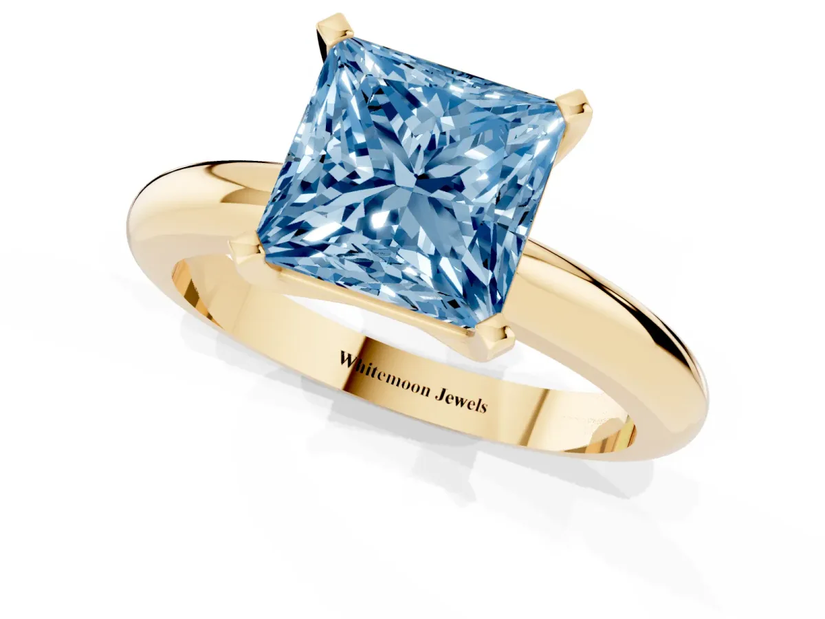 Fancy Blue Princess Cut Diamond Solitaire Engagement Ring with Round Band and Four-Prong Setting Yellow gold
