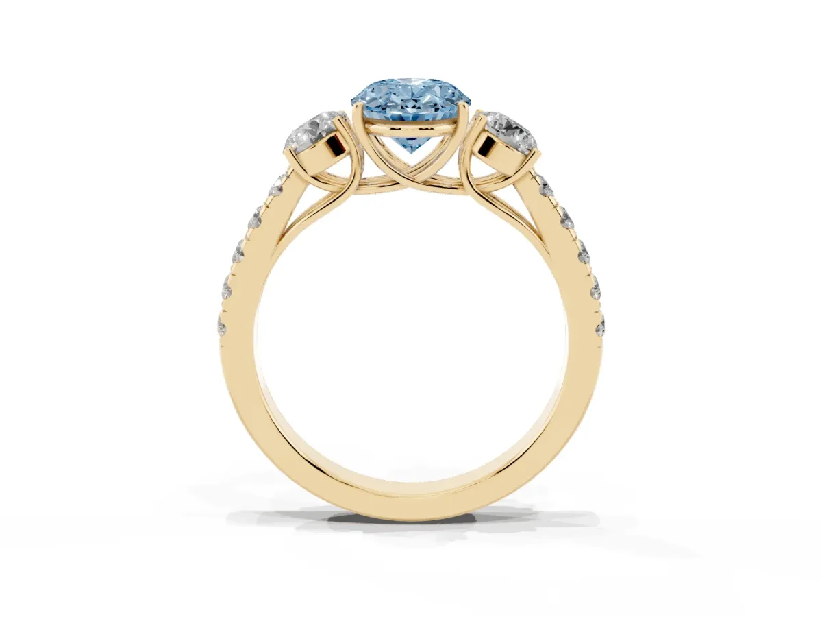 Fancy Blue Oval Cut Cut Diamond Three-Stone Ring with Round Side Stones and Pavé Band Yellow gold