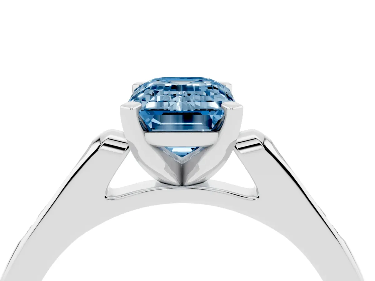 Fancy Blue Emerald Cut Diamond Solitaire Ring with Channel Set Round Band and Prong Setting Silver