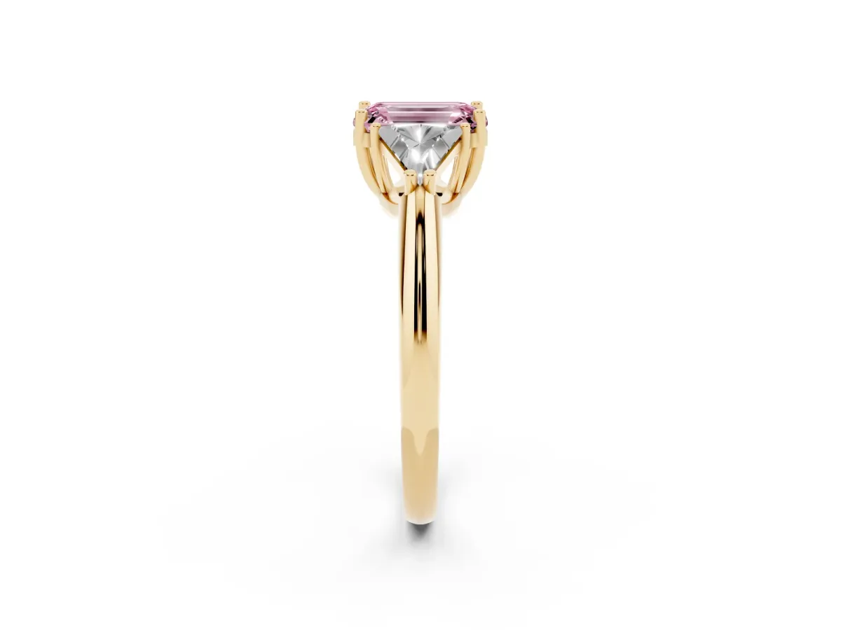 Fancy Pink Three-Stone Emerald Cut Diamond Engagement Ring with Trillion Side Stones and Prong Setting Yellow gold