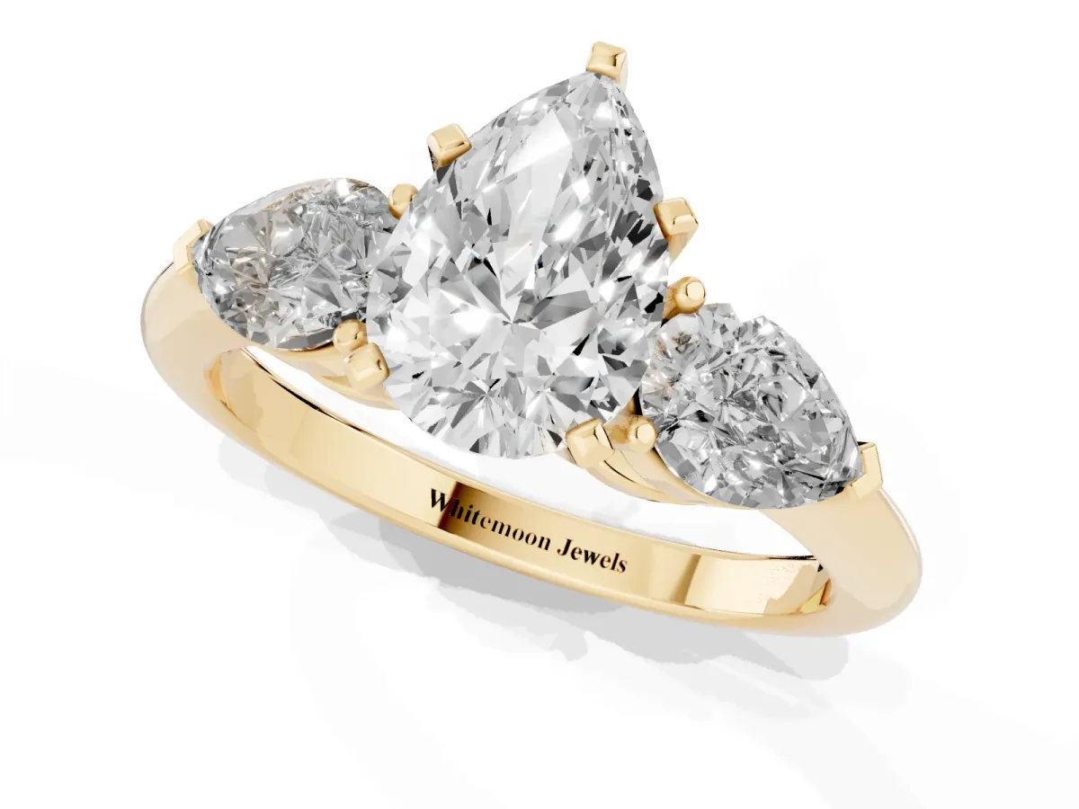 Three-Stone Pear Cut Diamond Ring with Pear Side Stones and Four-Prong Setting Yellow gold