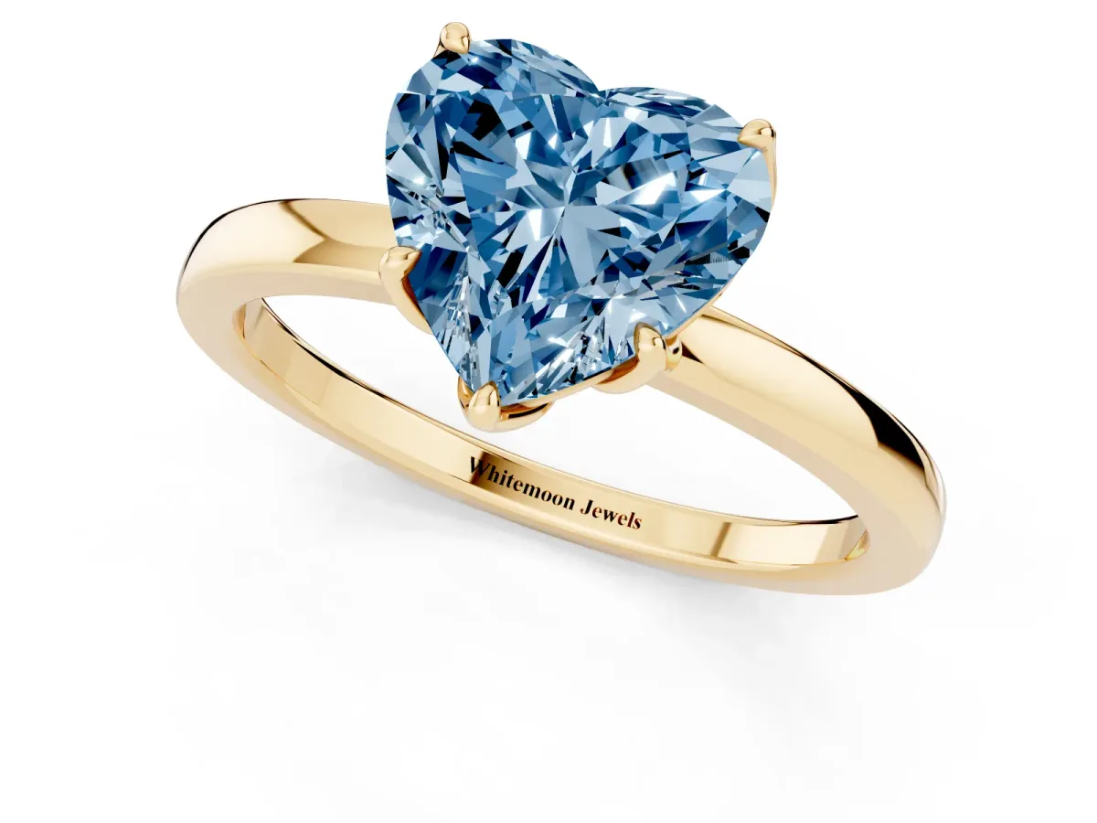 Fancy Blue Heart Cut Diamond Solitaire Ring with Thin Band and Prong Setting Yellow gold
