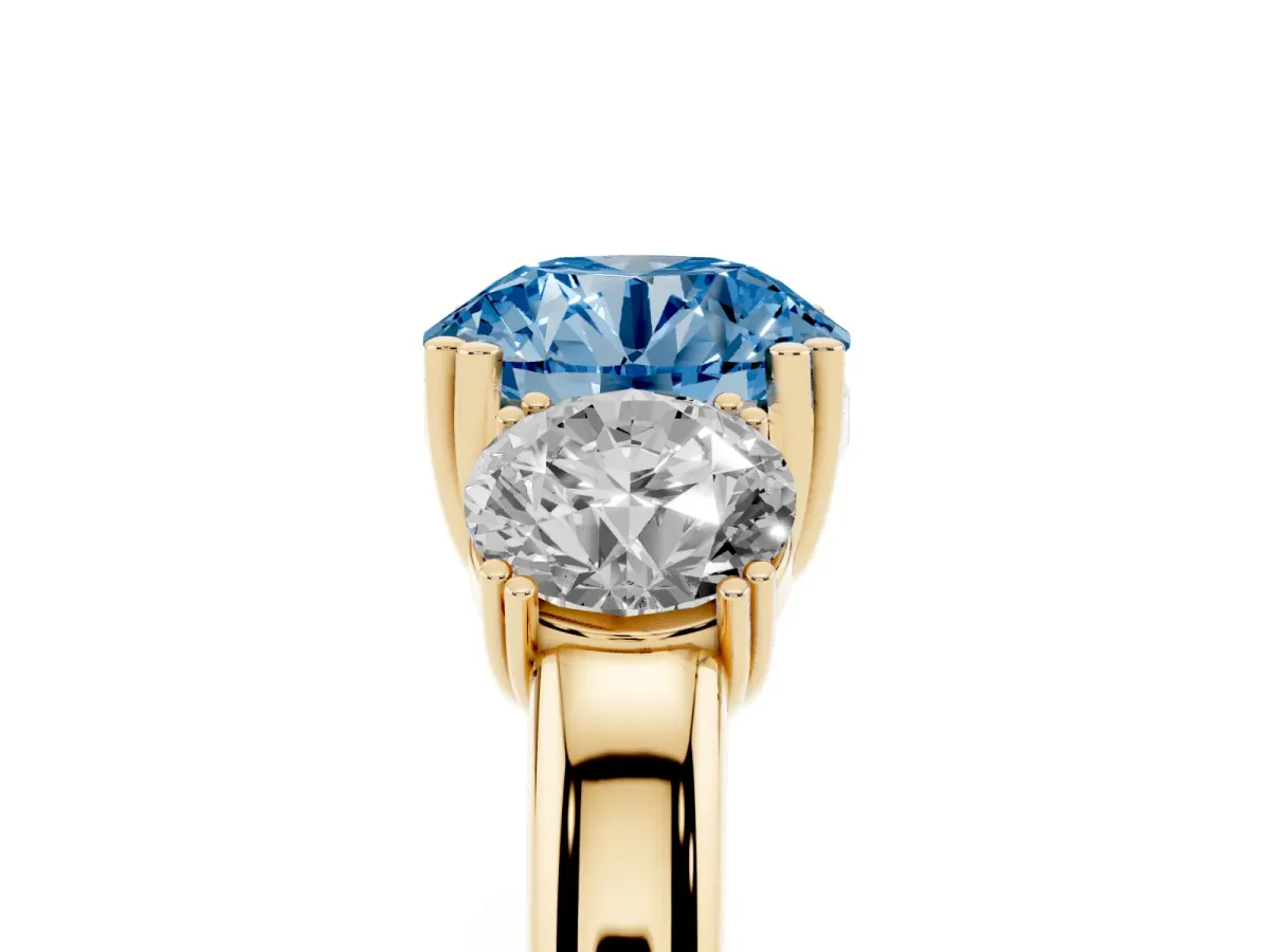 Fancy Blue Three-Stone Round Cut Cut Diamond Ring with Channel Set Band and Four-Prong Setting Yellow gold