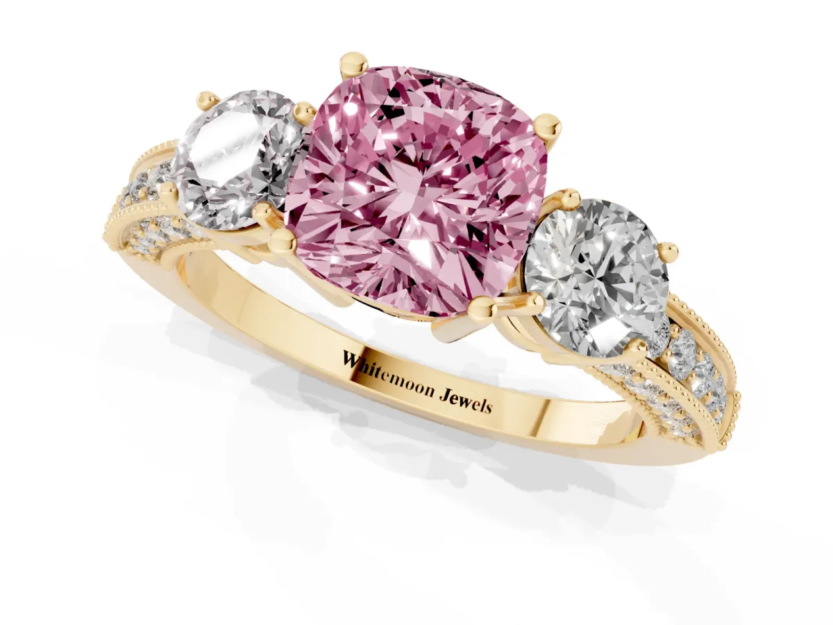 Fancy Pink Cushion Cut Three-Stone Diamond Ring with Pavé Band and Four-Prong Setting Yellow gold